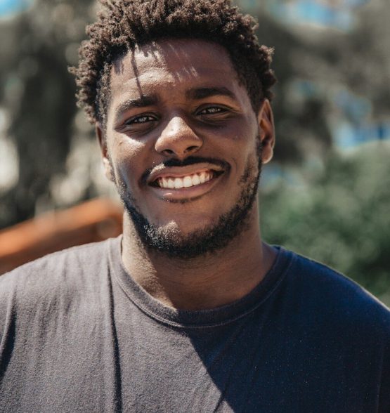 selective focus of man smiling during daytime