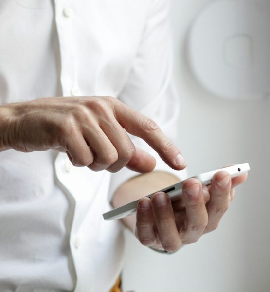 person holding white Android smartphone in white shirt