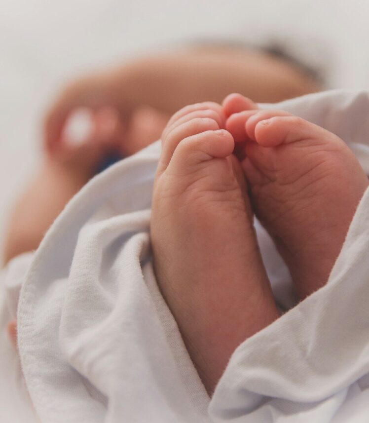 baby covered with white blanket