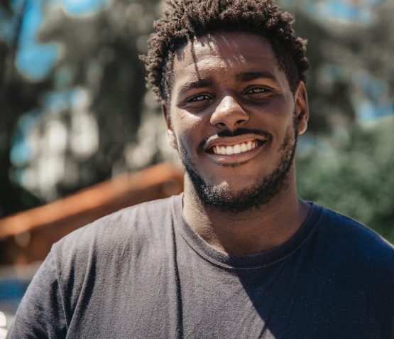 selective focus of man smiling during daytime