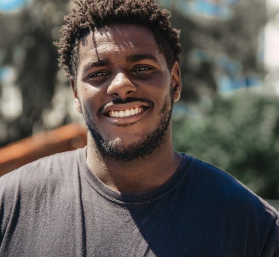 Photo by Elizeu Dias selective focus of man smiling during daytime