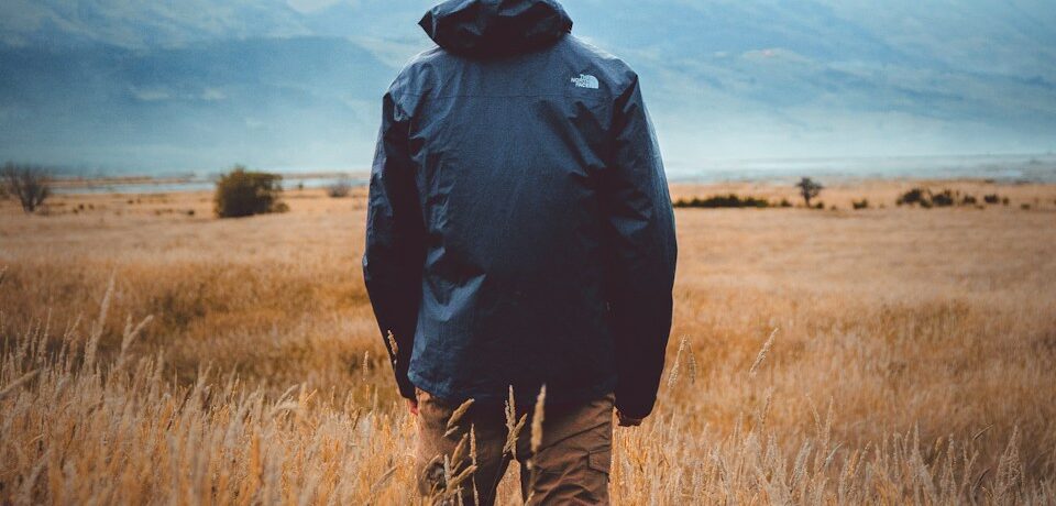 man in middle of wheat field