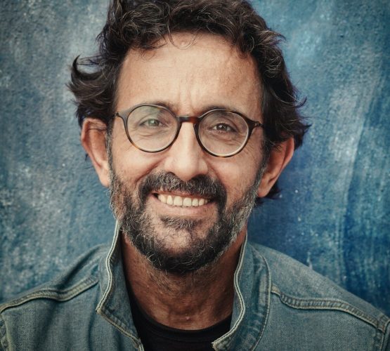 Photo by Christian Buehner man in gray denim jacket wearing black framed eyeglasses