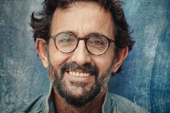 Photo by Christian Buehner man in gray denim jacket wearing black framed eyeglasses