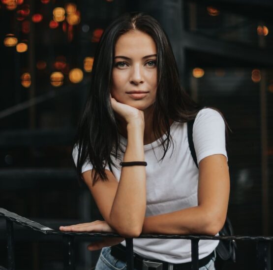 woman leaning on black handrail