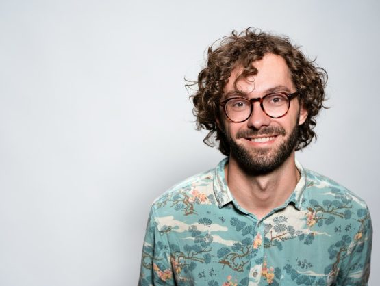 smiling man with glasses and beard portrait