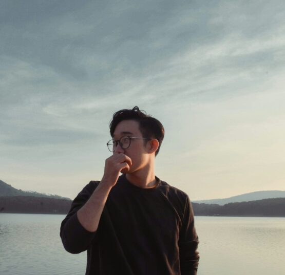 Photo by Thái An woman in brown long sleeve shirt wearing black framed eyeglasses