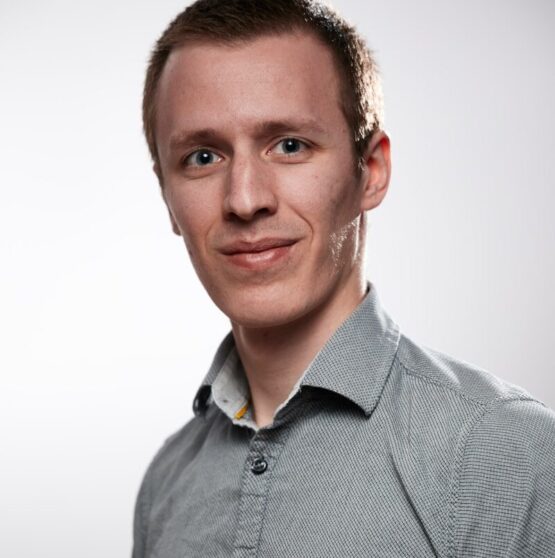Photo by Ludovic Migneault man in gray button up shirt