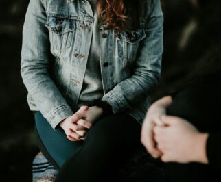 woman in denim jacket sitting