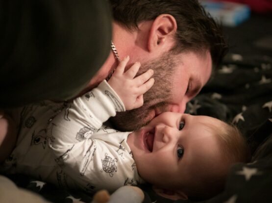 man kissing baby