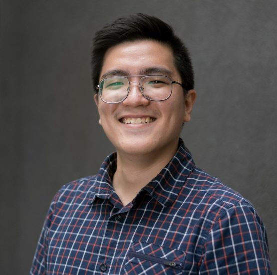 a man with glasses smiling for the camera