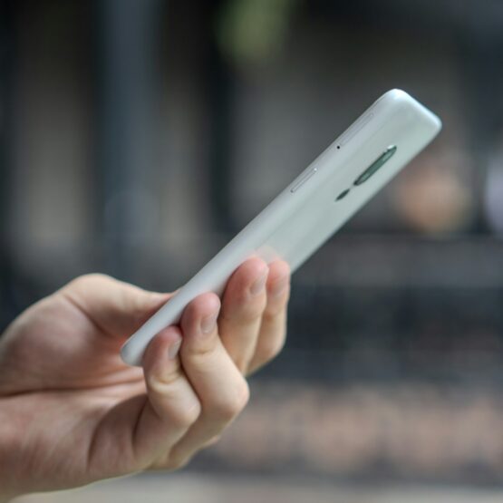 A close up of a person holding a cell phone