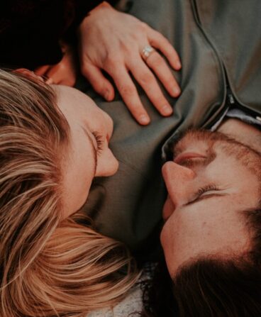a woman stares into a man's eyes lovingly