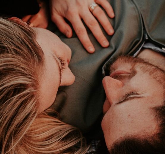a woman stares into a man's eyes lovingly