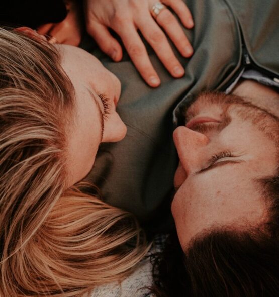 a woman stares into a man's eyes lovingly