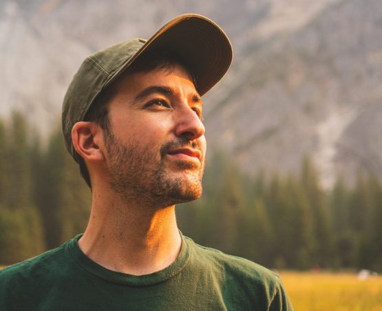 Photo by Jeffrey Keenan man in green crew neck shirt and black hat