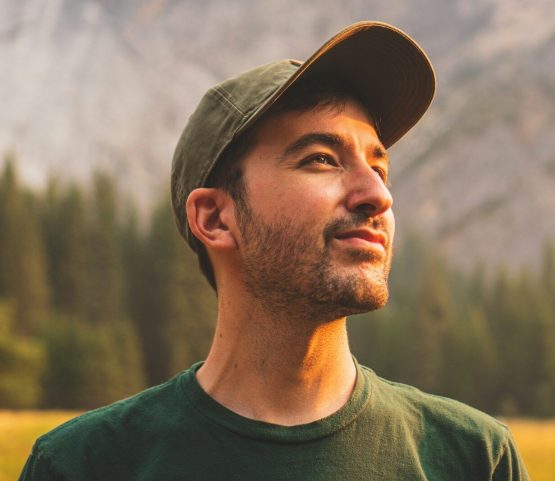 Photo by Jeffrey Keenan man in green crew neck shirt and black hat