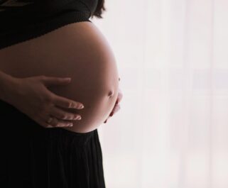pregnant woman cradling her belly