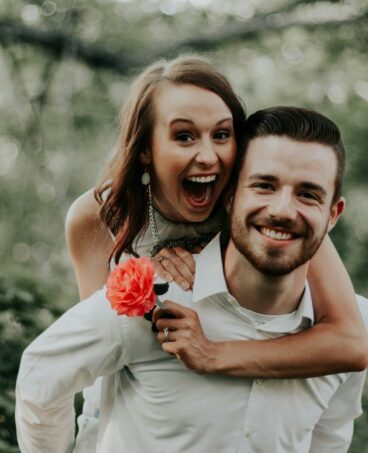 woman riding on back of man